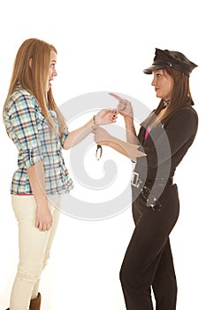 Woman cop handcuff woman pointing