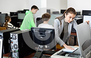 Woman copying notes on copy machine in library computer lab