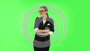 Woman coquettishly smiling while looking at camera. Green screen