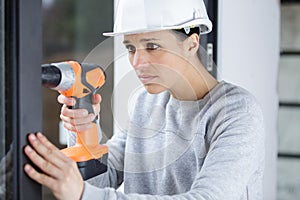 woman with cordless drill ready for home repairs