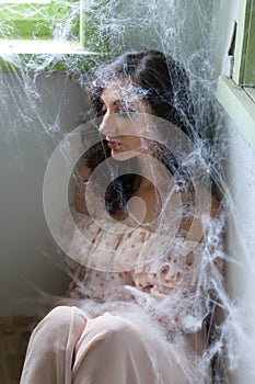 Woman in corner with cobwebs