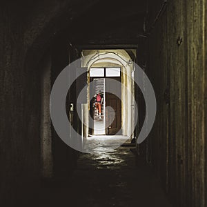 Woman in the corridor in an old tenement house