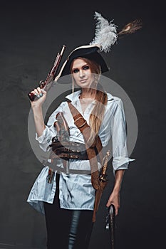 Woman corsair wearing shirt and hat with guns