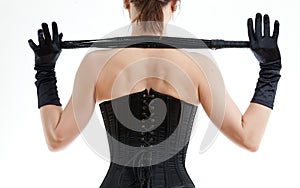 Woman in a corset and whip