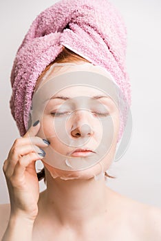 Woman with cosmetic mask anti-wrinkle on face on light background