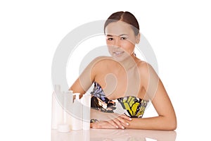 Woman with cosmetics for skincare and bodycare