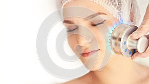 Woman cosmetology procedure. Light face treatment. Medical skin repair. Anti wrinkle. Color skincare