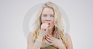 Woman with cough, virus and respiratory problem with health issue and flu in studio on white background. Young female