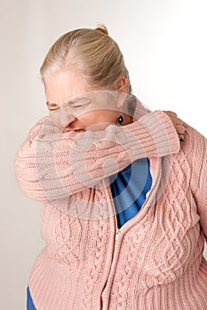 Woman Coughing/Sneezing into Elbow