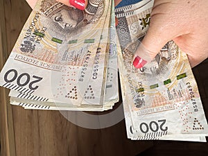 woman count polish money pln zl zloty banknotes for shopping