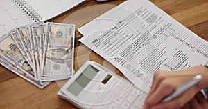 Woman counting bills and signing document for subsidy