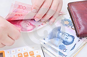 Woman counting Chinese yuan banknotes