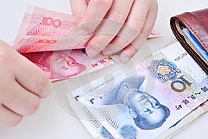 Woman counting Chinese yuan banknotes