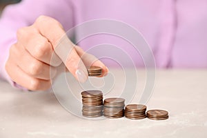 Woman counting coins at light table