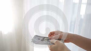 Woman counting dollar bills. Money calculation. Cash money payment