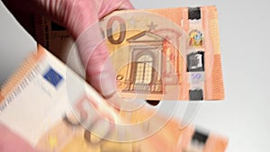 woman counting fifty euro banknotes