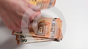 woman counting fifty euro banknotes