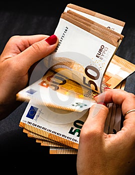 Woman counting money, counting EURO close up