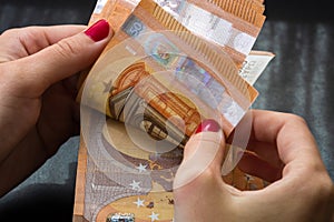 Woman counting money, counting EURO close up