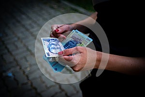 Woman counting money, counting LEI close up