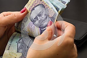 Woman counting money, counting LEI close up