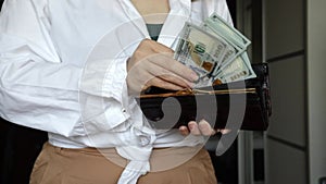 woman counting money dollars in wallet,stocks and profits, stock exchanges, income growth