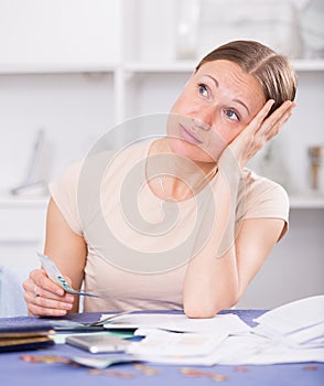 Woman counting money for paying bills