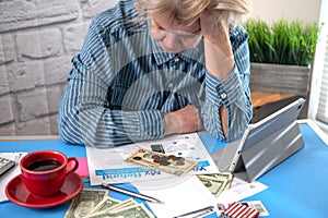 woman is counting money and preparing a financial report. Worried about lack of money