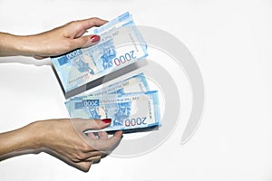 A woman`s hand holds paper money. Russian rouble