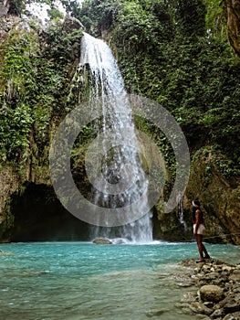 Woman couple alone in deep forest waterfall, inambakan falls in Cebu Island in Philppines