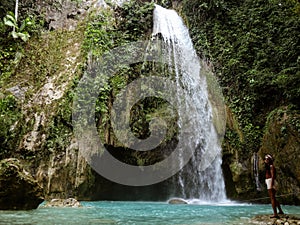 Woman couple alone in deep forest waterfall, inambakan falls in Cebu Island in Philppines