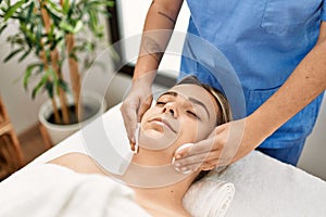 Woman couple having facial treatment cleaning skin face at beauty center