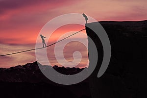 Woman with courage walking on the rope at mountain