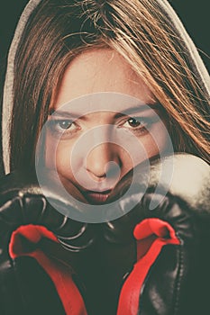 Woman cover face with boxing gloves.