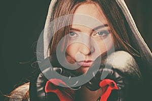 Woman cover face with boxing gloves.