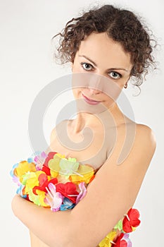 Woman cover her naked body by flower garland photo