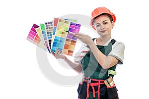 Woman in coverall holding color swatch and brush isolated on white