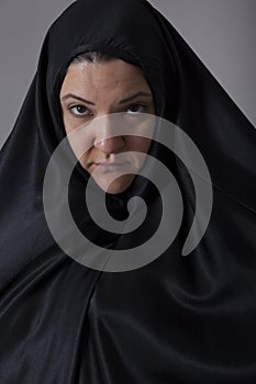 Woman covered with black veil