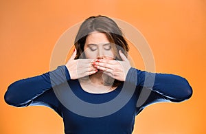 Woman covering closed mouth. Speak no evil concept