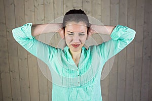 Woman covering ears and eyes closed