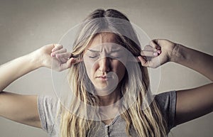 Woman covering ears photo