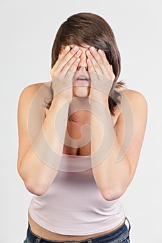 Woman covering face in denial