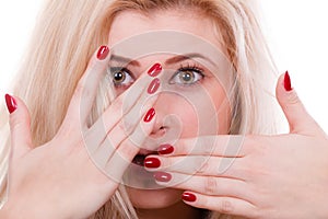 Woman covering face with hands showing red nails