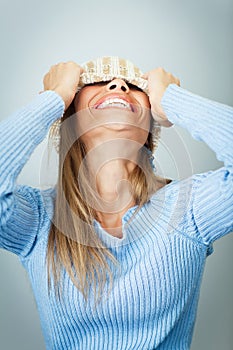 Woman covering face with hat