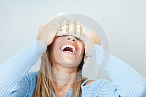 Woman covering face with hat