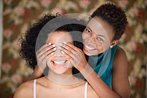 Woman covering friends eyes