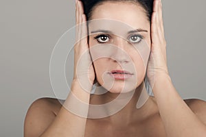 Woman Covering her Ears