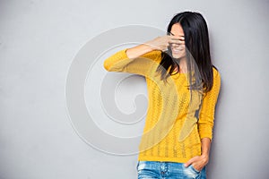 Woman covering her eyes with fingers