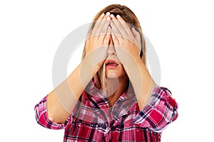 Woman covering her eyes with hands. See no evil concept