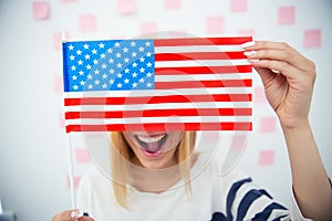 Woman covering her eyes with USA flag
